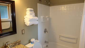 A bathroom with a sink, toilet, and shower.