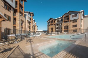 A hotel with a swimming pool, outdoor seating, and multiple balconies. - Silverado 126 | Mountain View | Patio | Pool | Short Walk to Lift (Park City)