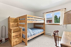 A bunk bed with storage drawers, a desk, and a chair in a room with a window. - Peaceful Elkhorn Aspen Retreat with Amenity Access (Sun Valley)