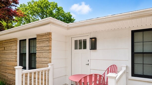 A house with a porch, a white door, and a small table with chairs. - Home in Union Pier, MI (Union Pier)