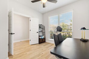 A room with a dining table, chairs, a ceiling fan, and a window with blinds. - Fully furnished and appointed home for corporate lease.   All utilities paid. (Manor)