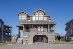 A two-story building with a balcony and a sign for 'Azure Dreams Resort Realty.' - 5472 - Azure Dreams Oceanside (Nags Head)