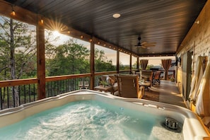 A hot tub on a wooden deck with outdoor furniture and a view of trees. - Antler Lodge+Sunset+Nature+Hot Tub+Resort Pools (Hollister)