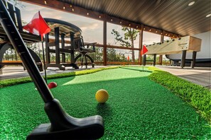 A miniature golf course with artificial turf, a golf club, and a golf ball. - Fairway Lodge+Hot Tub+Golf+Sunset+Resort Pools (Hollister)