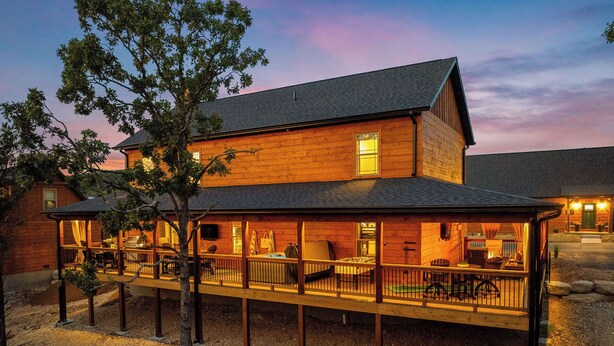 A two-story wooden building with a covered patio area. - Fairway Lodge+Hot Tub+Golf+Sunset+Resort Pools (Hollister)