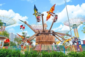 A carousel with multiple seats and a central wooden structure.