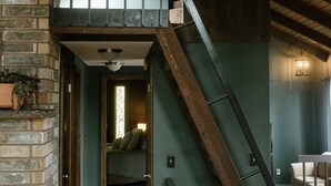 A wooden staircase leading to a loft bedroom with a view of the living area below. - Entire home in Moscow, ID (Moscow)