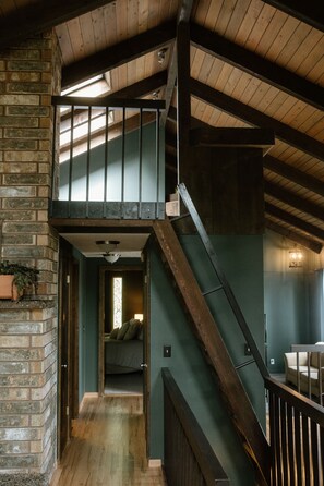 A wooden staircase leading to a loft bedroom with a view of the living area below. - Entire home in Moscow, ID (Moscow)
