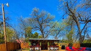 A colorful pathway leading to a building with a sign that reads 'PAINTS'. - The Backyard Cantina Walk to Fair Park (Dallas)