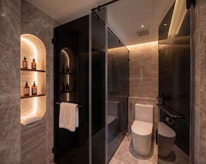A modern bathroom with a glass-enclosed shower, a toilet, and a vanity with shelves holding toiletries. - Villa V The One and Only, Managed by H Hospitality (El Nido)