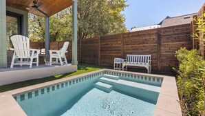 A backyard with a swimming pool, two Adirondack chairs, a bench, and a wooden fence. - Beautiful 4-bedroom - Pool, Patio, Grill - Close to UT & Rainey (Austin)