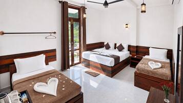 A hotel room with a bed, a desk, a chair, a coffee maker, and a window with curtains.