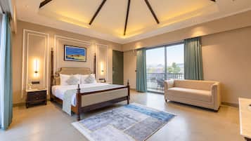 Una habitación de hotel con una cama grande, un sofá, un balcón con vistas y un cuadro en la pared.