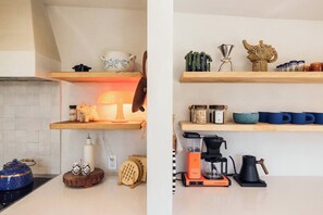 A kitchen with wooden shelves, a coffee maker, and a kettle. - Pool, Hot Tub, Stars, Views, Yoga Pad, Bocce, BBQ (Joshua Tree)