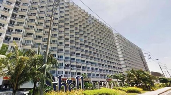 A large, multi-story hotel building with a prominent sign at the entrance. - Cozy Scandinavian-inspired Condo With Balcony Facing SM Mall of Asia (Pasay)