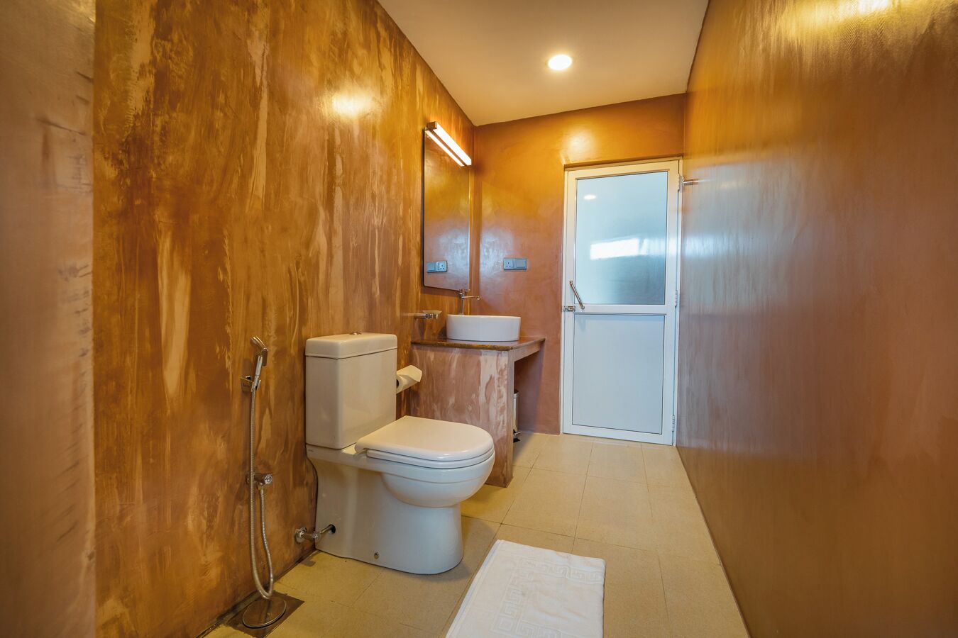 A bathroom with a toilet, sink, and shower.