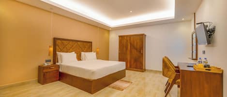 A modern bedroom with a bed, bedside tables, a wardrobe, a desk, and a chair.