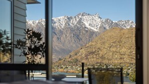 A mountain landscape with a town in the valley below. - Lakeview on Goldrush (Queenstown)