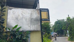 A building with a signboard advertising amenities like a meeting room, rooftop cafe, and free WiFi.