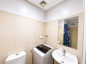 A bathroom with a toilet, a washing machine, a sink, and a shower. - Urban Bliss 1BR Stay Front of MOA at Shell Residence Tower C (Pasay)