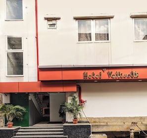 A building with a sign reading 'Hotel Wailuku' and a staircase leading to the entrance.