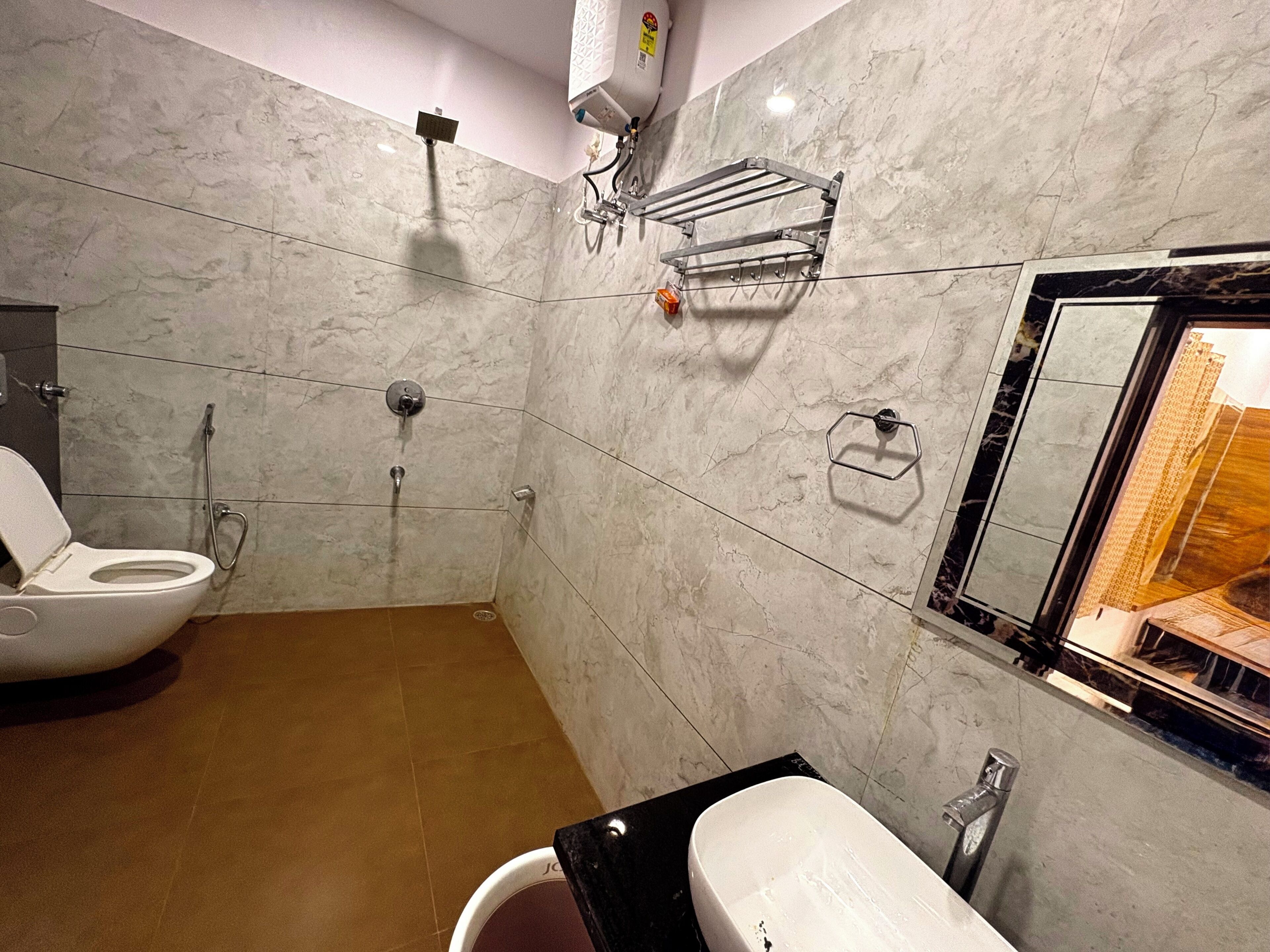 A bathroom with a toilet, sink, and shower.