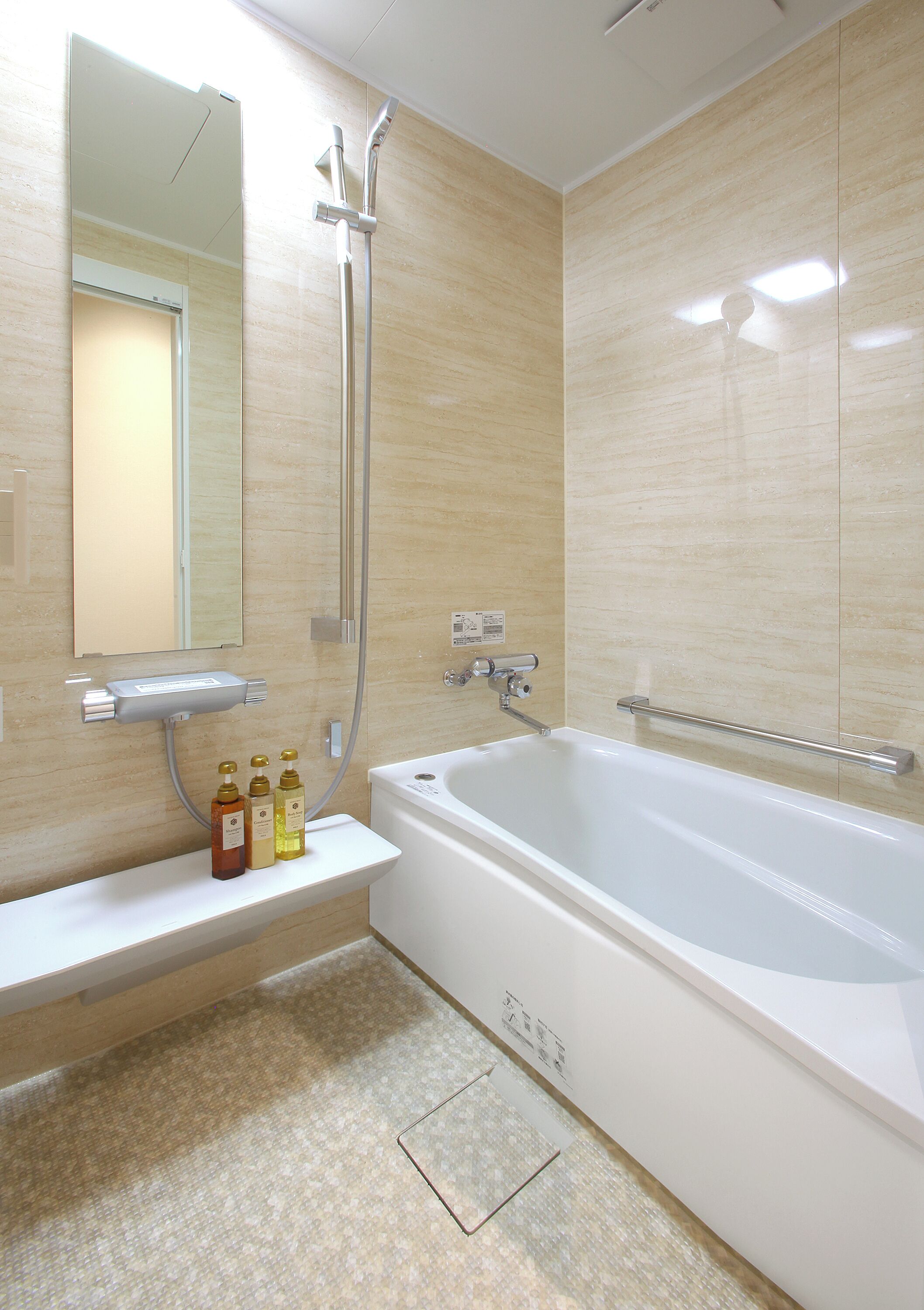 A modern bathroom with a bathtub, a shower, and a vanity with a mirror.