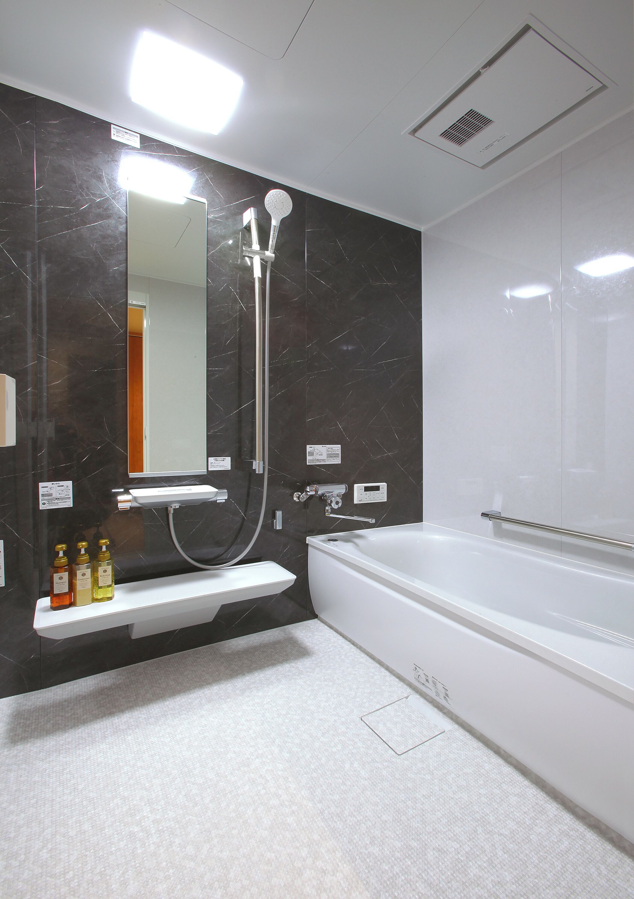 A modern bathroom with a large bathtub, a separate shower area, and a vanity with a mirror.