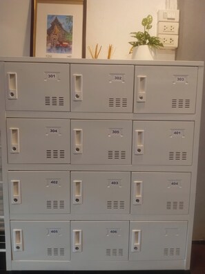 A set of grey metal storage units with numbered compartments, likely used for storing guest belongings. - Nature's Heaven Hostel (Chiang Mai)