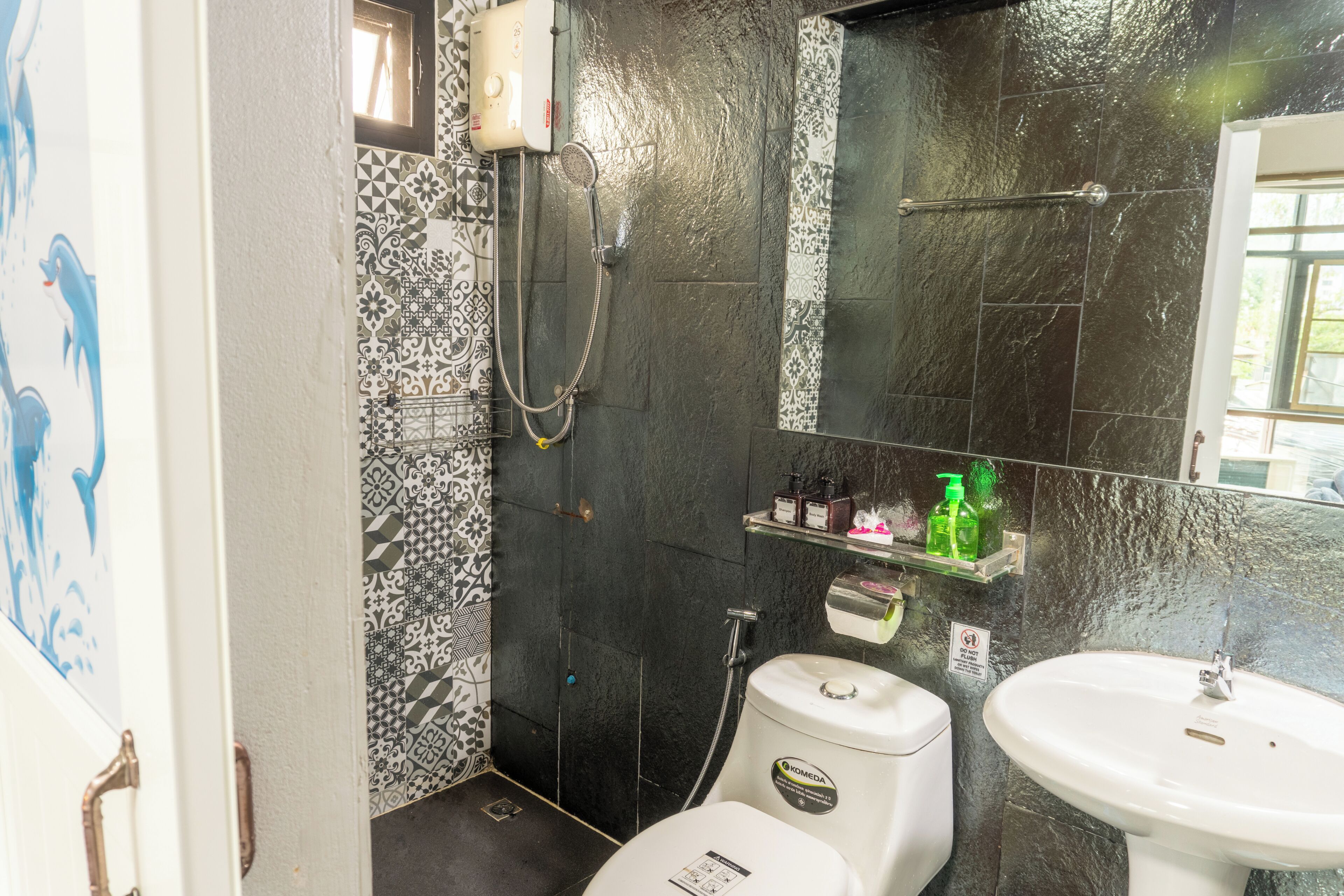 A bathroom with a shower, toilet, and sink.