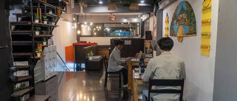 A modern interior with a seating area, a counter, and a wall with a decorative piece.