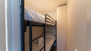 A bunk bed with a small closet and a door. - Houseboat With Rooftop Terrace (Wolphaartsdijk)