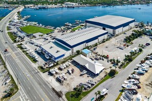 A large industrial building with a parking lot and boats docked nearby. - New Listing w/ Limited Time Discounted Rates! Sun, Sand & Your Own Backyard Oasis w/ Private Pool! (Panama City Beach)