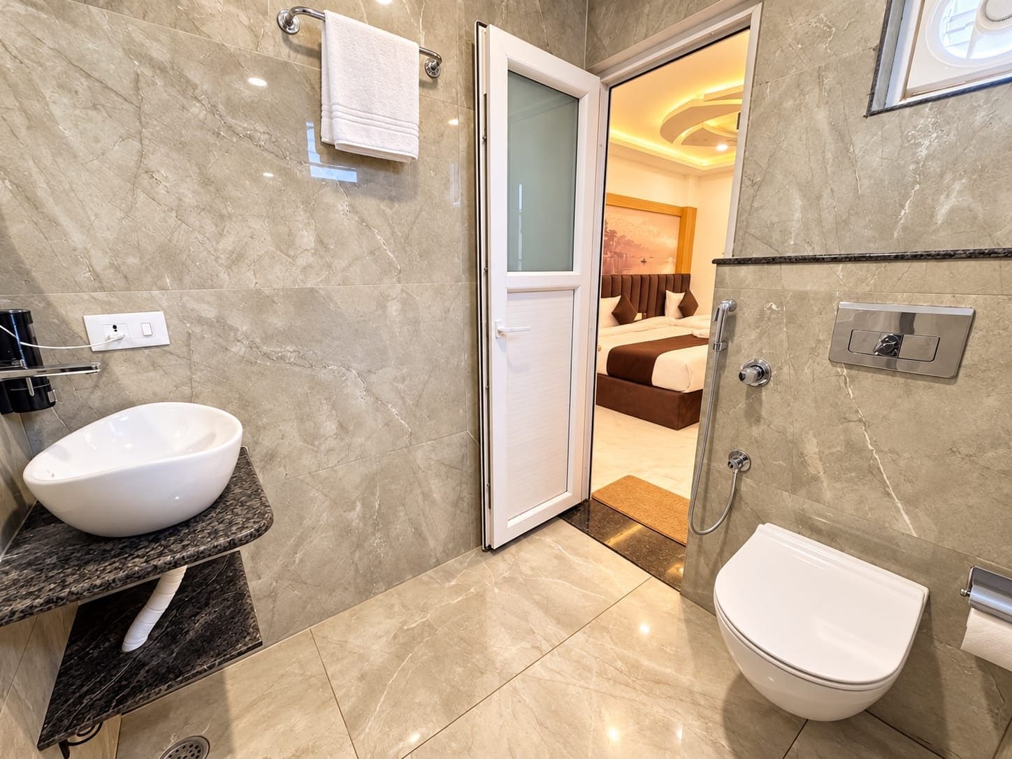 A bathroom with a white sink, a toilet, and a shower.