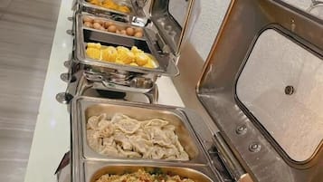 A buffet line with various food options.