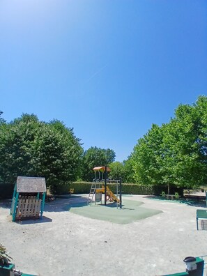 A playground with a slide and climbing structure, surrounded by trees and a clear sky. - A quiet villa overlooking the Gulf of Terre Blanche in the town of Tourrettes. (Tourrettes)