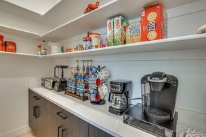 A kitchen with a white countertop, various food items, and kitchen appliances. - Game Room & Stunning Mtn Views! Cedar City Home (Cedar City)