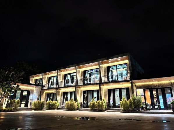 A multi-story hotel with a modern design, featuring balconies and large windows.