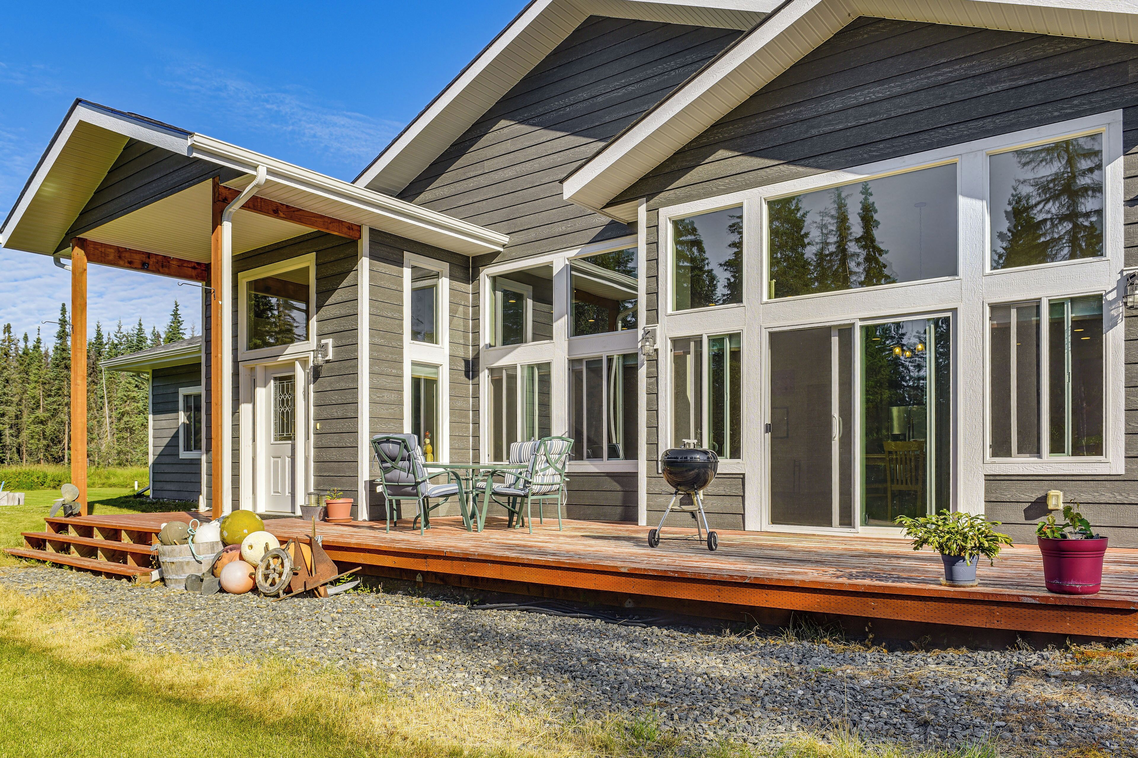 A modern house with a covered patio, large windows, and a deck.