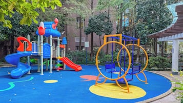 A playground with slides, swings, and climbing structures.