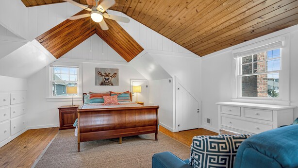 A bedroom with a sloped ceiling, a bed, a dresser, a window, and a ceiling fan. - Normandy Beach! Phenomenal Ocean Block Location (Lavallette)