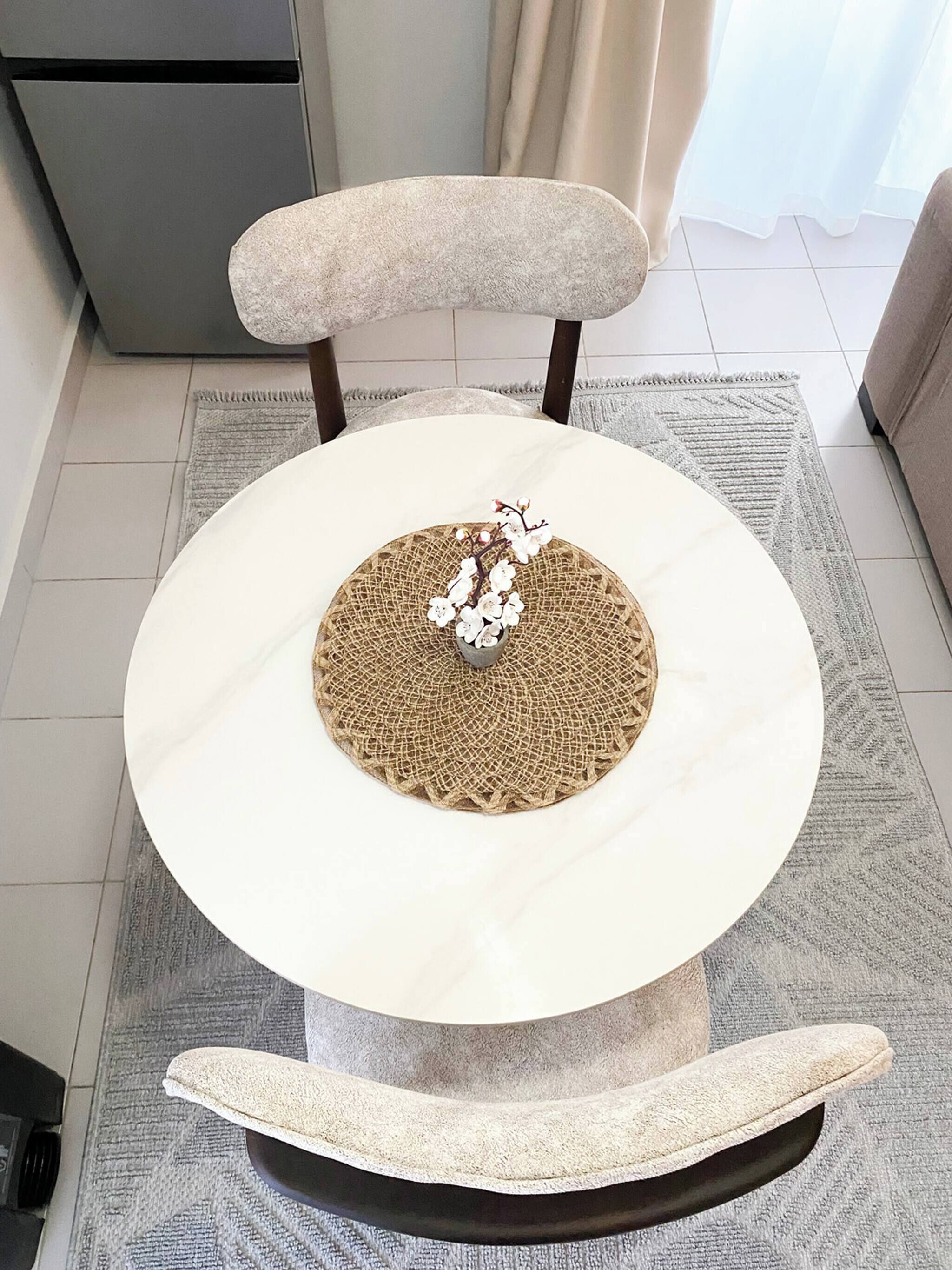 A cat tree with a circular platform and a scratching post.