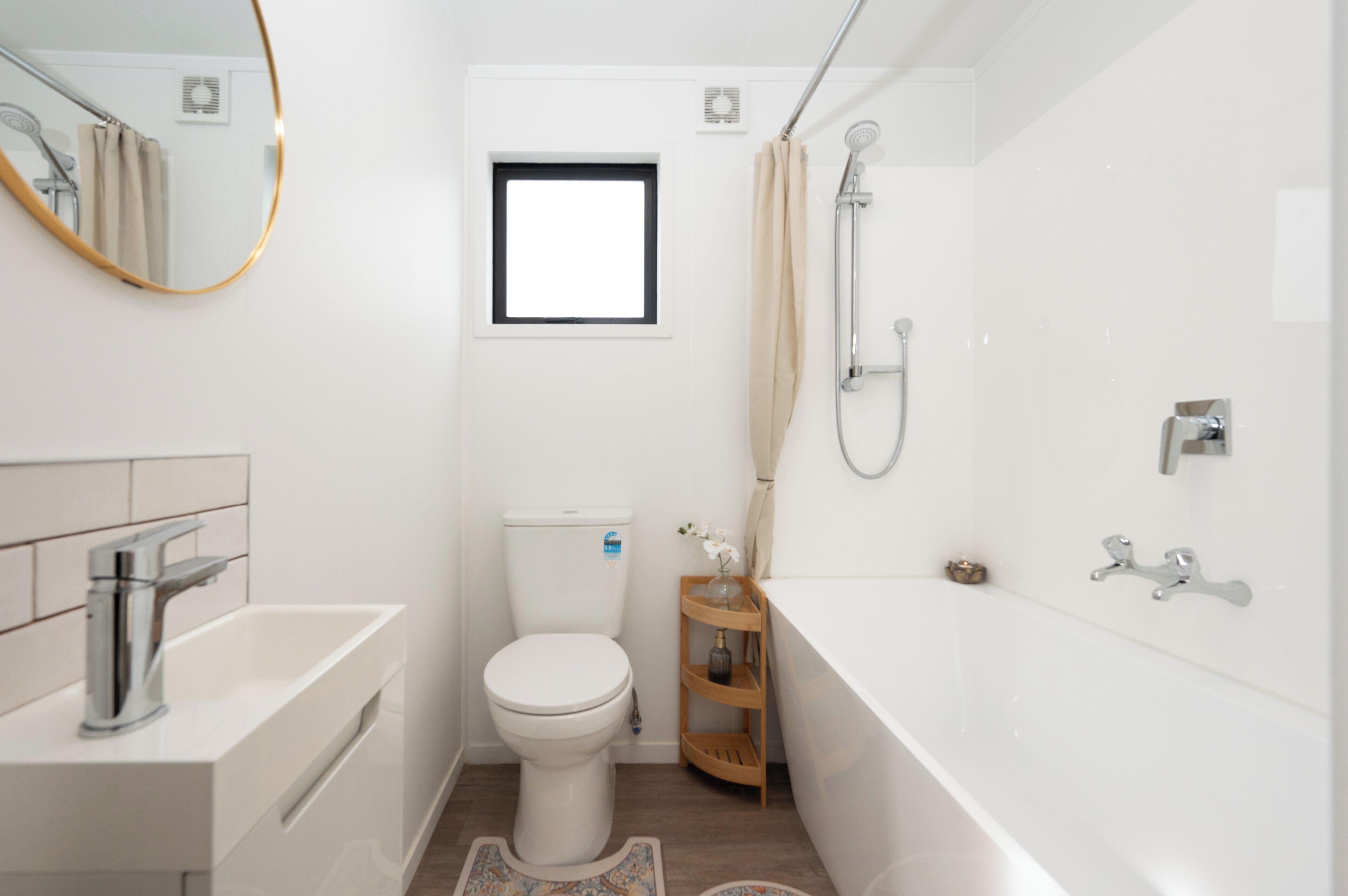 A modern bathroom with a toilet, sink, and bathtub.