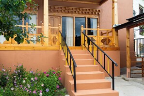 A staircase with a wooden handrail and a beige wall.