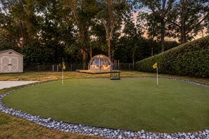 A well-maintained lawn with a clear path, a transparent dome structure, and a shed in the background. - Sleeps 14 ~ MiniGolf, HotTub, MovieRm, Sauna, Firepit (Columbus)
