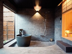 A modern bathroom with a large bathtub, a shower, and a wooden bench. - Imakusa-so, Nara, Naramachi - The Steam Bath House - (奈良市福智院町)
