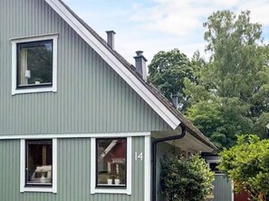 A two-story house with a grey exterior, white trim, and a visible number '14' on the side. - 5 Person Holiday Home in Brakne-hoby (Brakne-Hoby)
