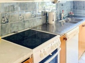 A kitchen with a stove, oven, and a sink. - 5 Person Holiday Home in Brakne-hoby (Brakne-Hoby)