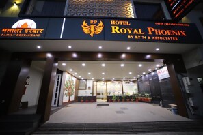 The entrance to Hotel Royal Phoenix with a prominent sign and a logo.