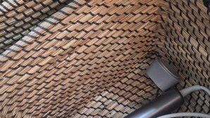 A woven basket containing a hairdryer and a power cord. - At Vale's House (Pescocostanzo)